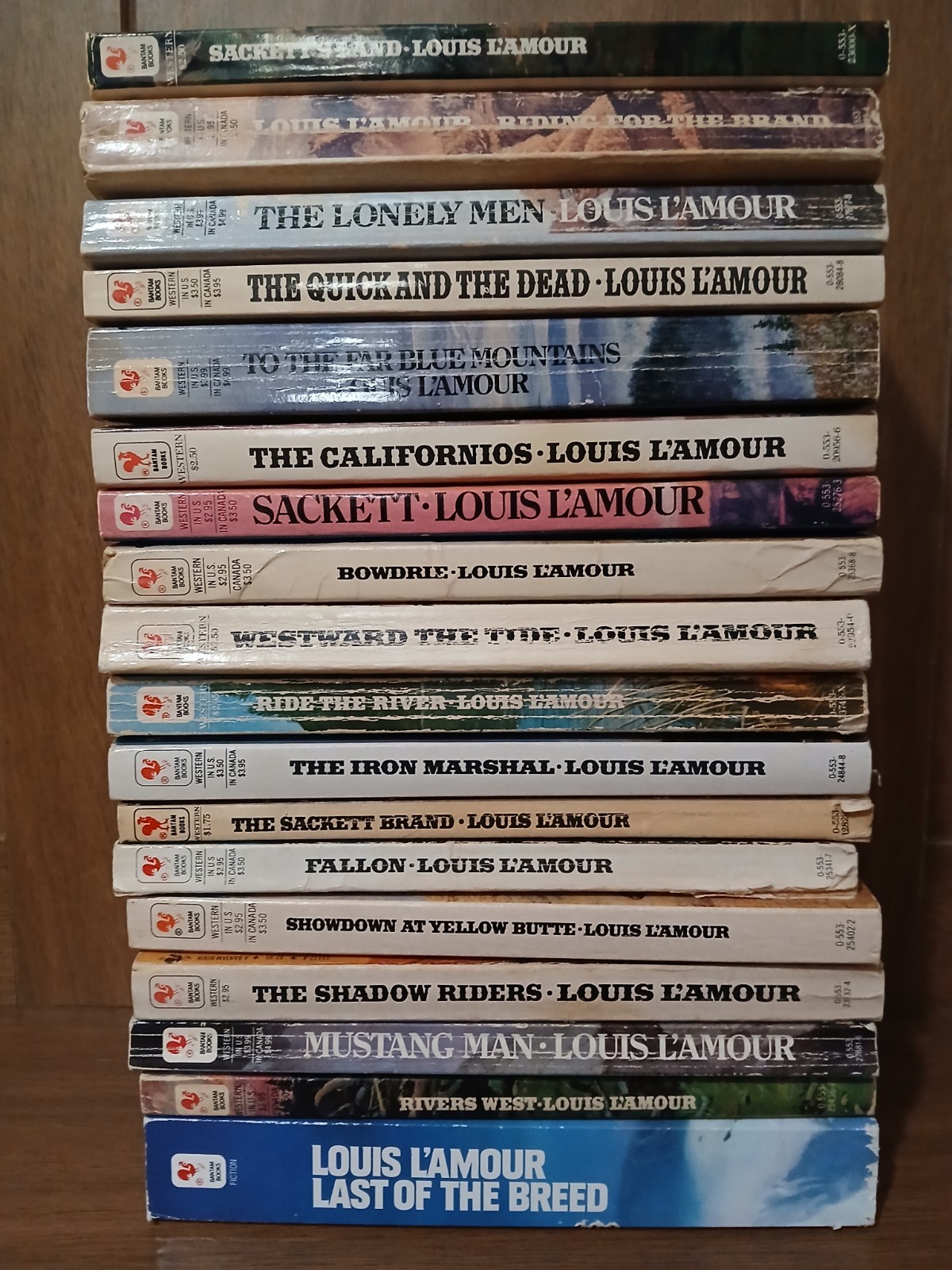 18 Vintage paperback western novels by the author Louis L’Amour.